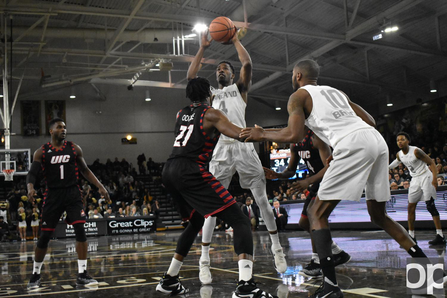 basketball players in the air toward a basket